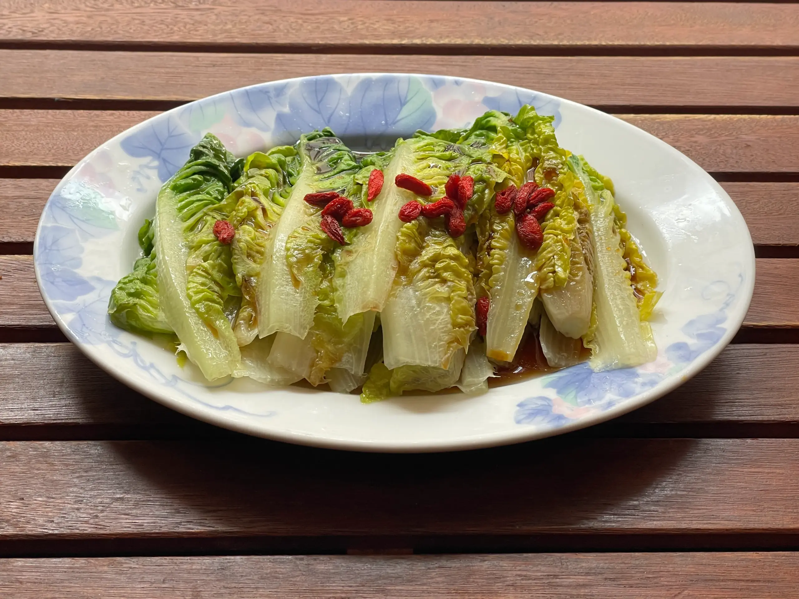 Goji berries placed fresh on the steamed romaine lettuce — not cooked to preserve nutrients